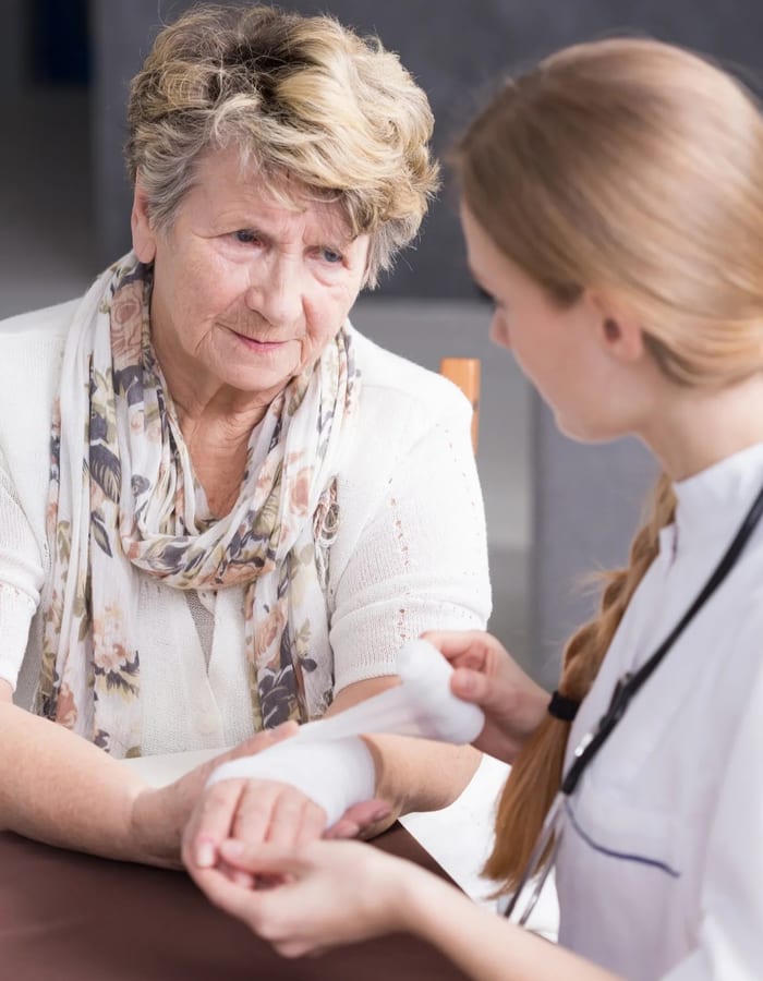 Clinician performing wound assessment and hygiene protocol